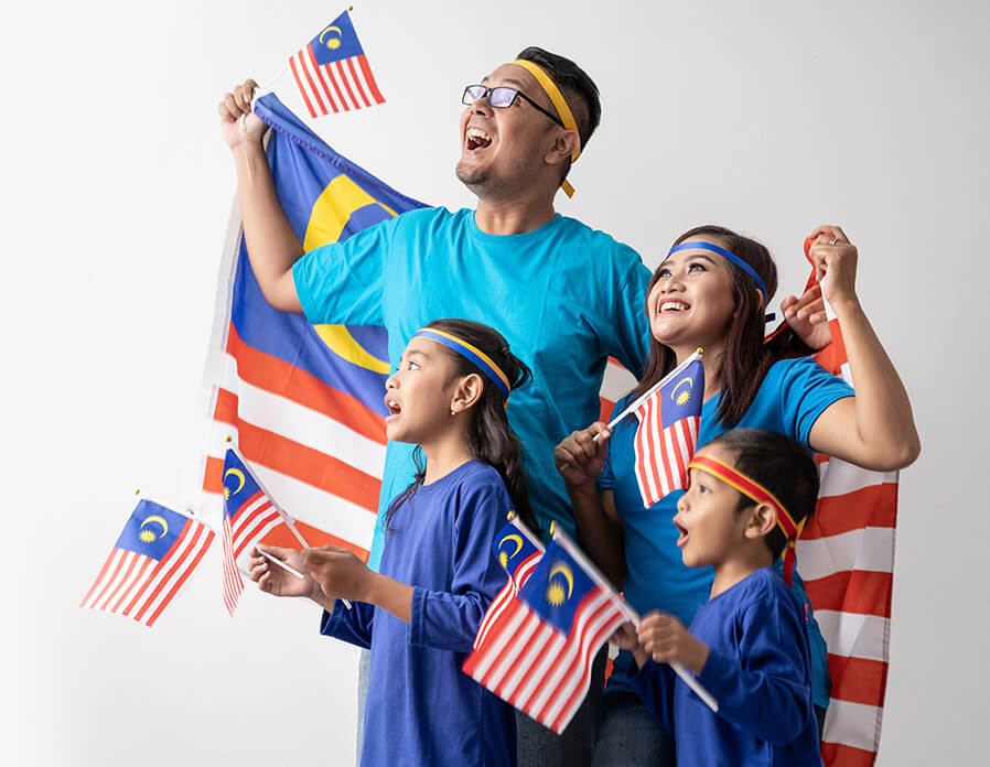 Malaysian family holding Malaysian flags