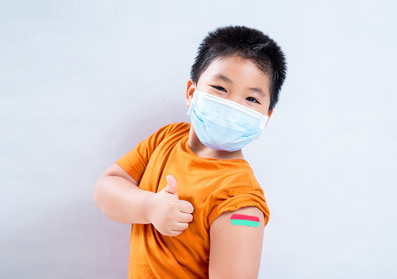 child vaccinated wearing face mask