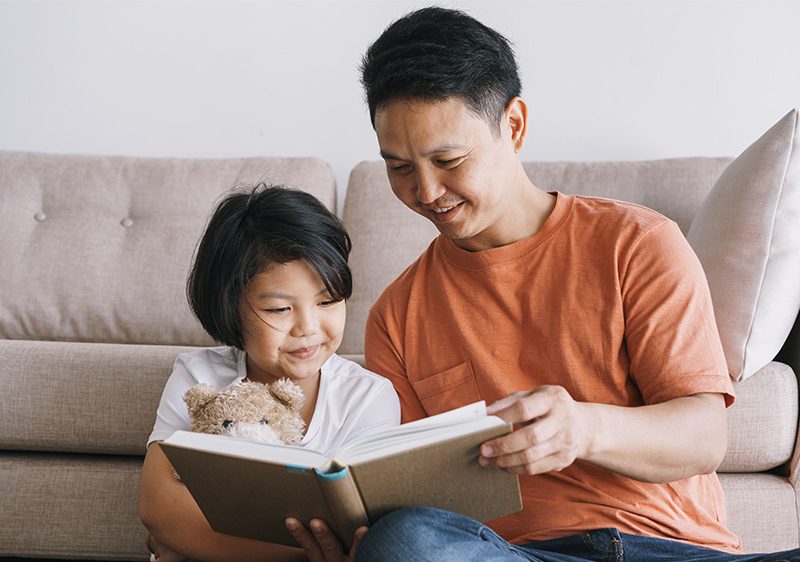 father reading to child